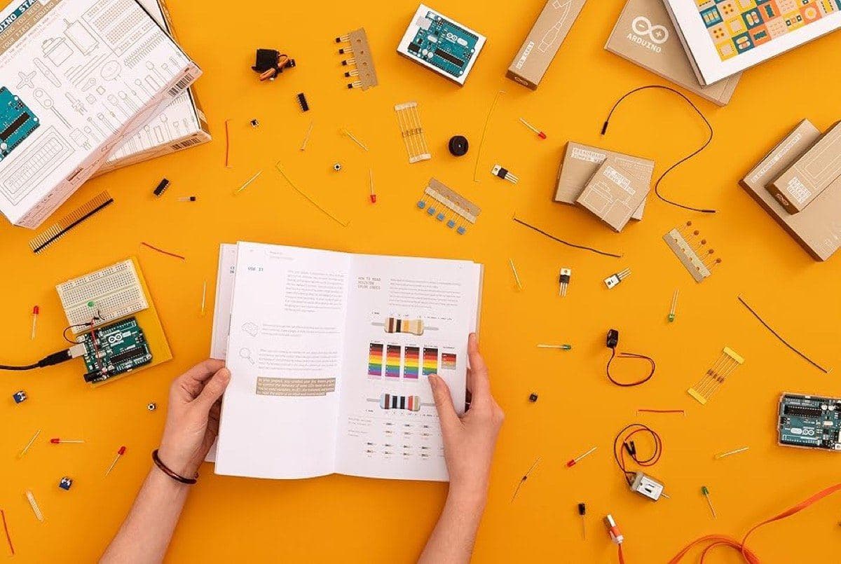 Arduino Starter Kit components laid out including board, breadboard, LEDs and sensors