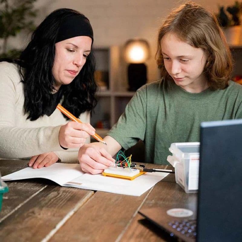 Parent and child working together on the Arduino Student Kit