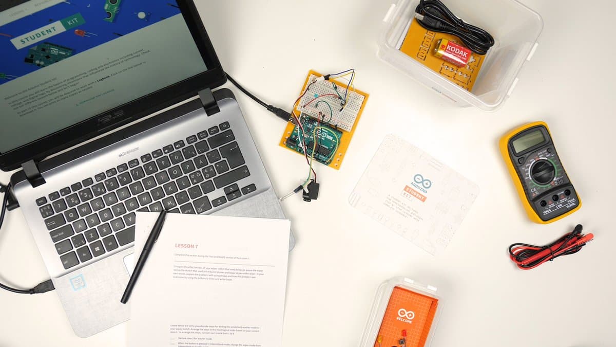 Arduino Student Kit opened box showing all components with a laptop