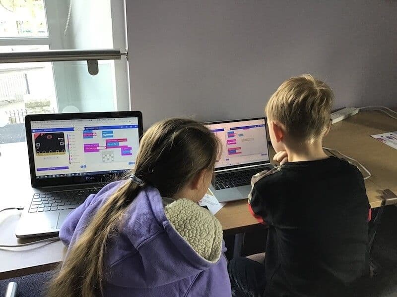 Two learners helping each other with MakeCode on a micro:bit