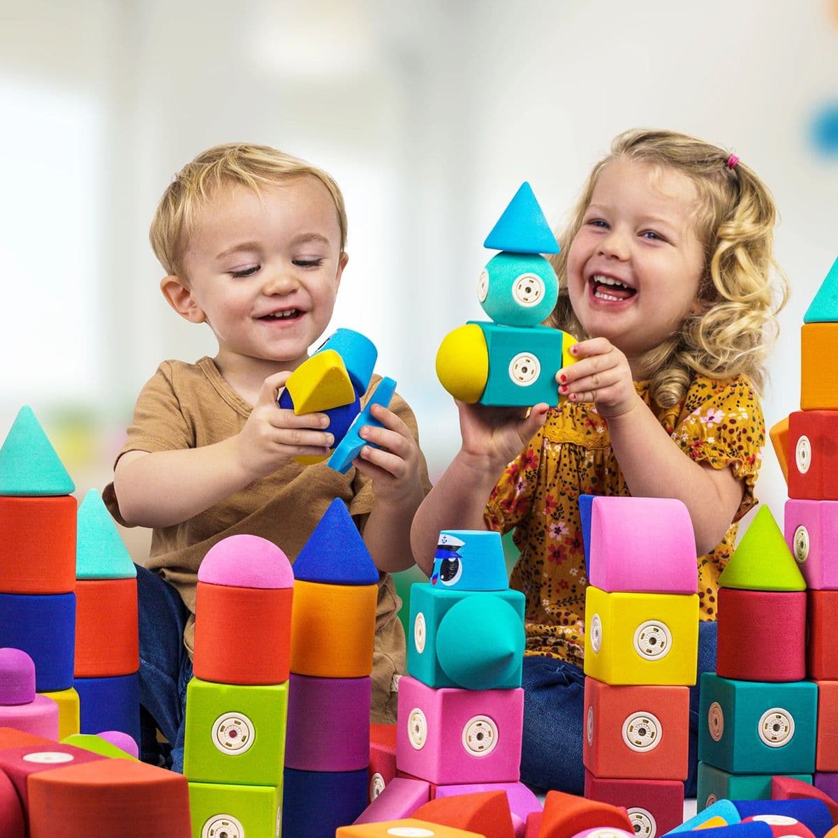 Children laughing and playing together with Blockaroo magnetic foam blocks