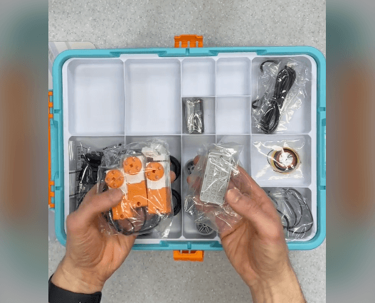 Hands unboxing the Makerzoid Robot Master Tournament kit