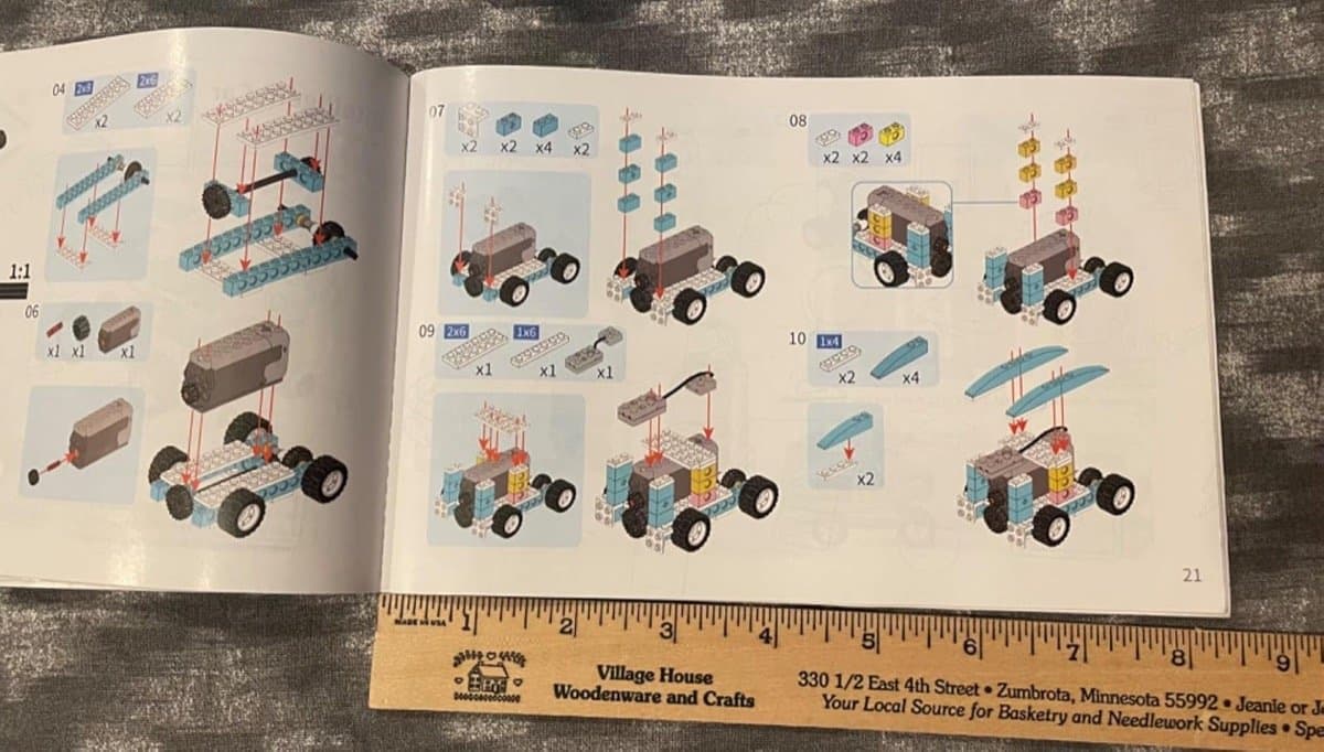 Instruction manual open showing 3D building guides
