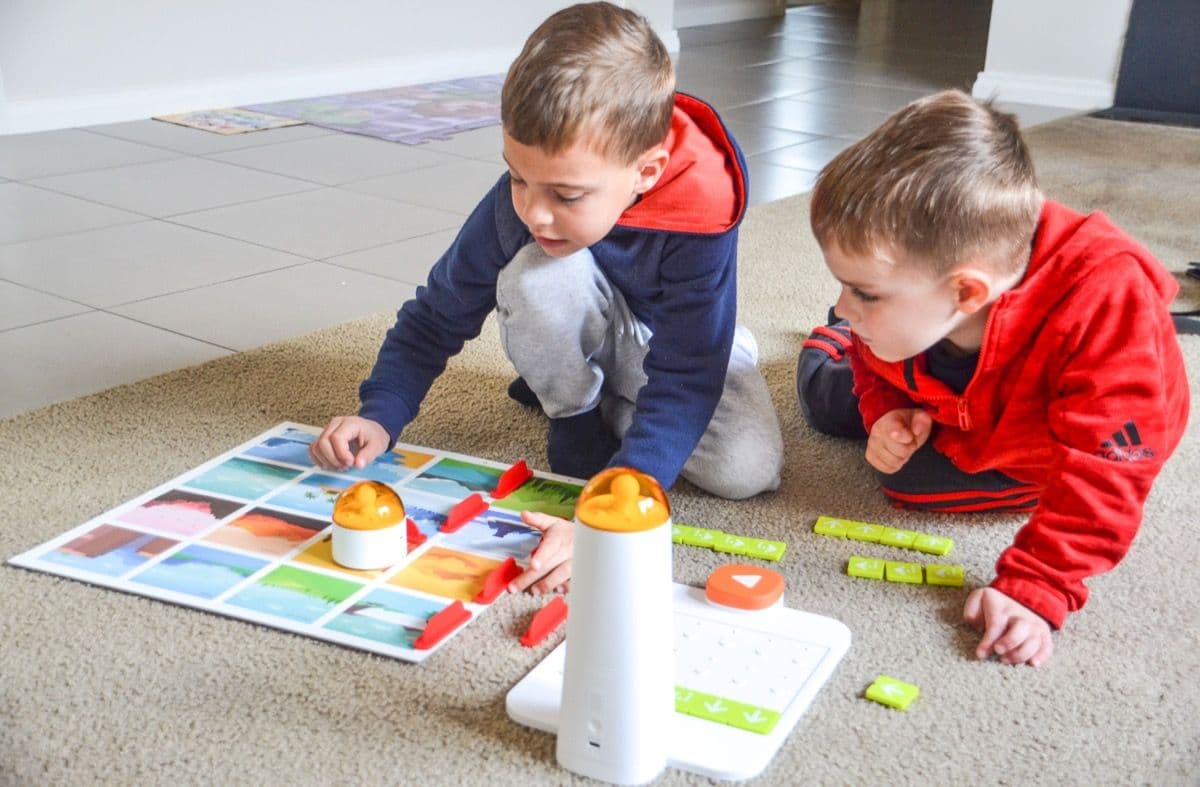 Two boys collaborating on coding challenges