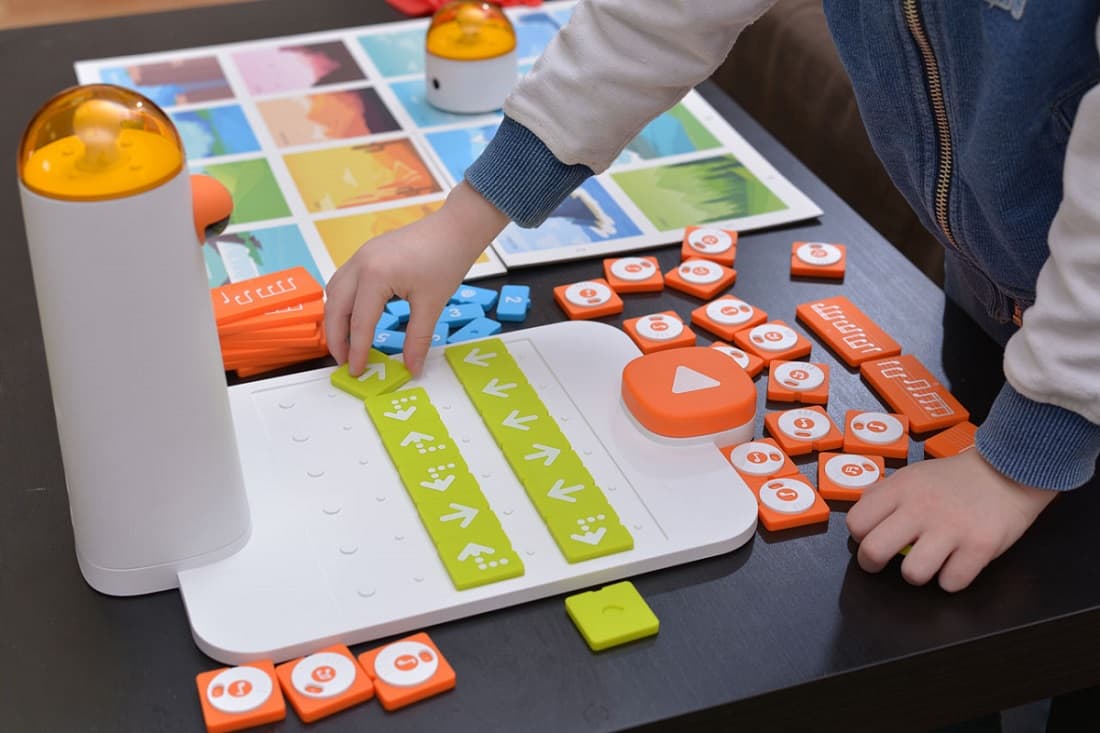 Child placing coding blocks on the control board