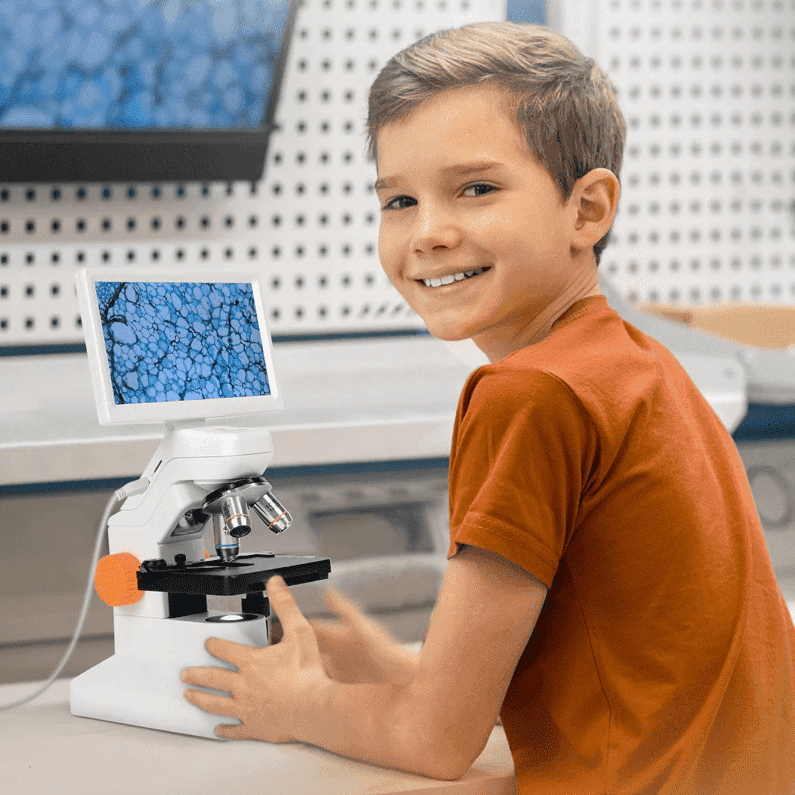 Boy smiling confidently next to the MatataStudio Digital Microscope