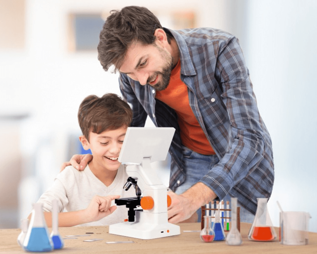 Father and son smiling together while using the MatataStudio microscope