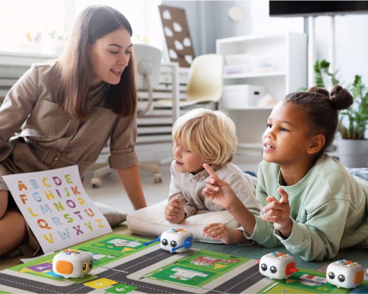 Teacher working alongside young learners using Tale-Bot Pro in a group setting