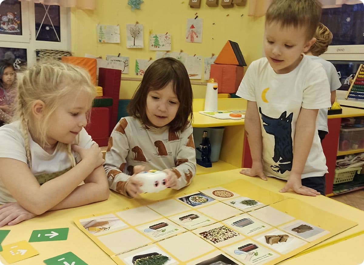 Three learners collaborating on a Tale-Bot Pro coding activity