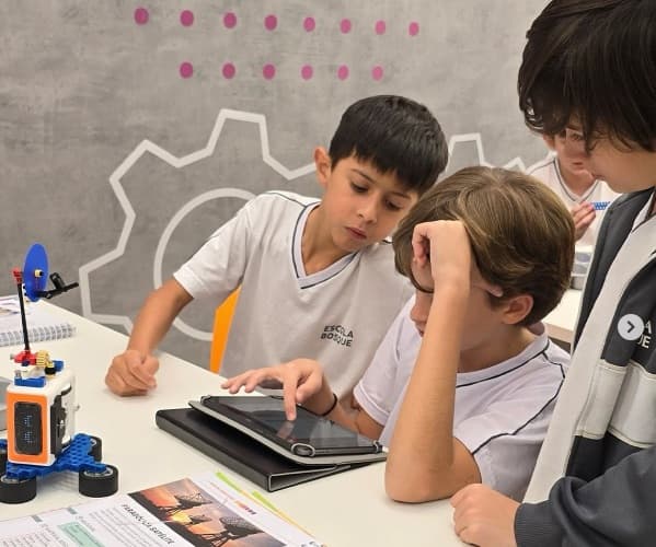 Kids collaborating on tablet together