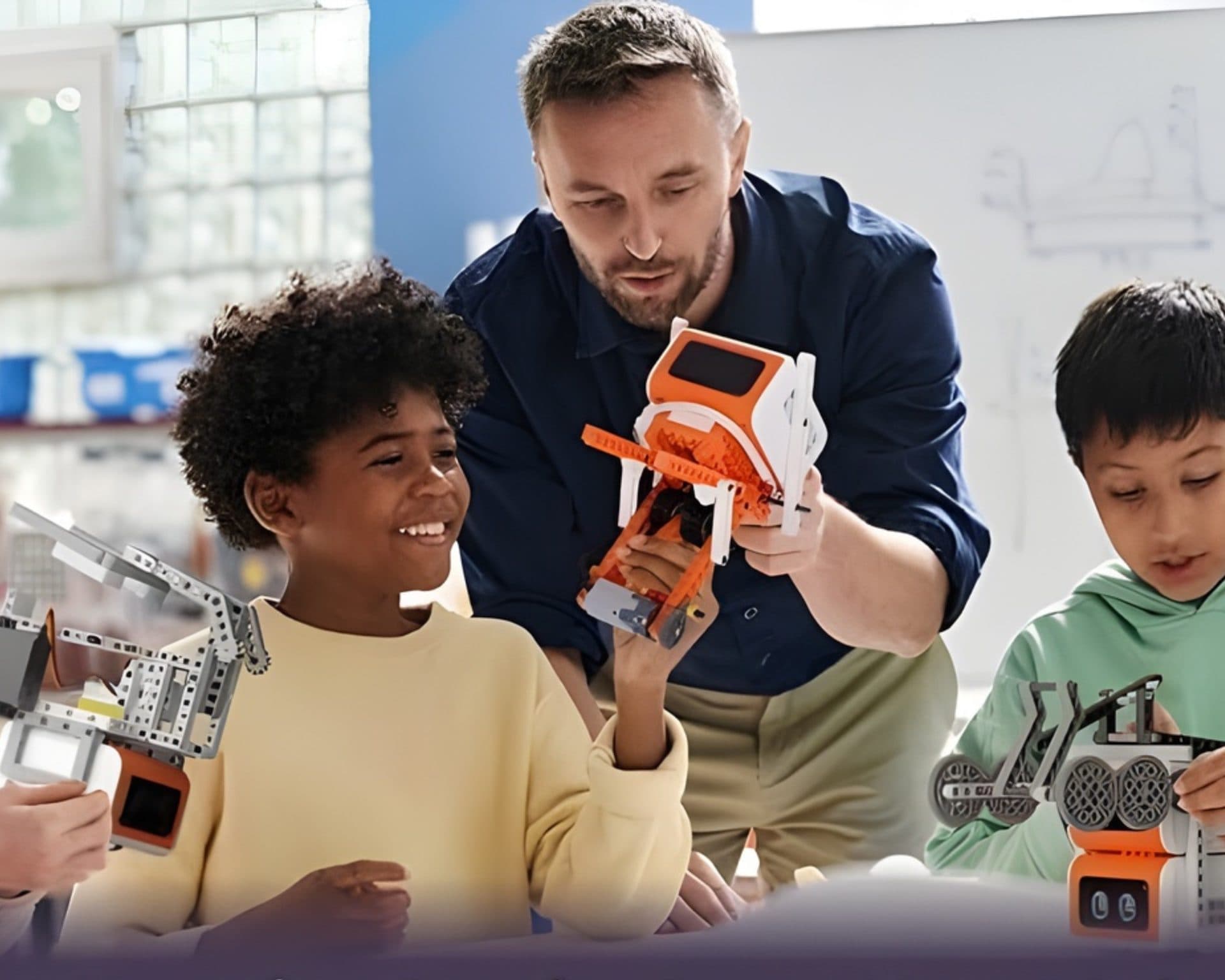Teacher with learners playing with VinciBot coding robots