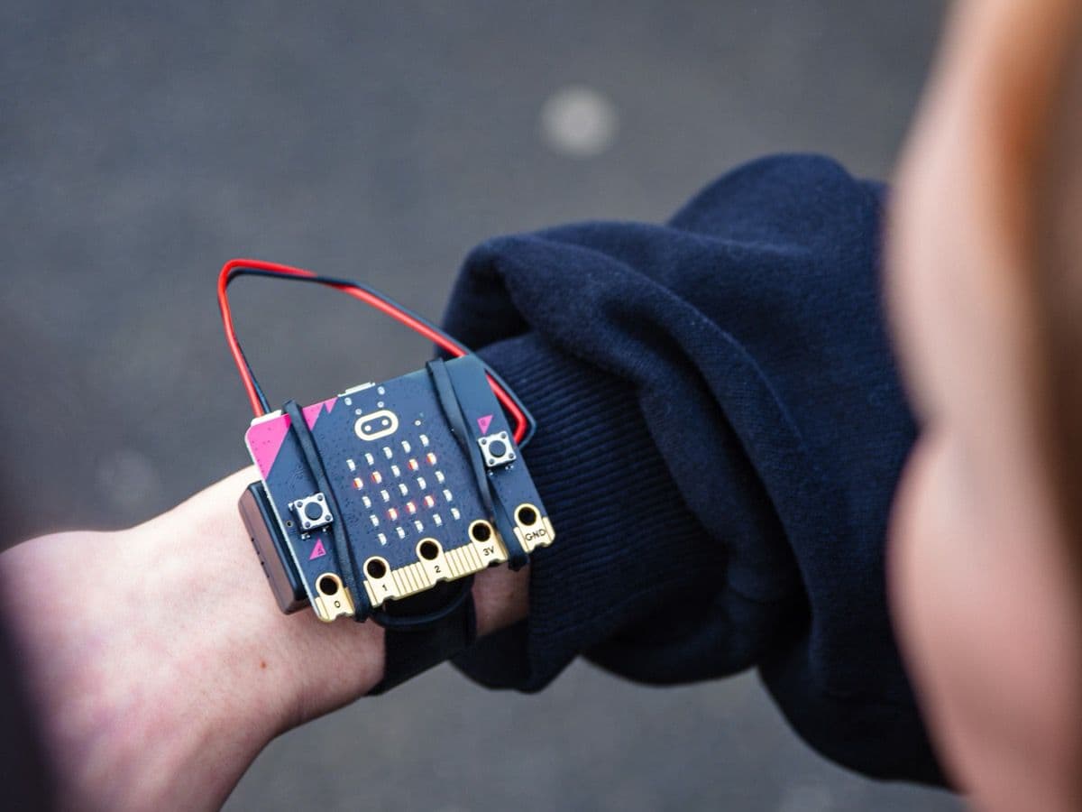 Learner examining their BBC micro:bit strapped to their wrist