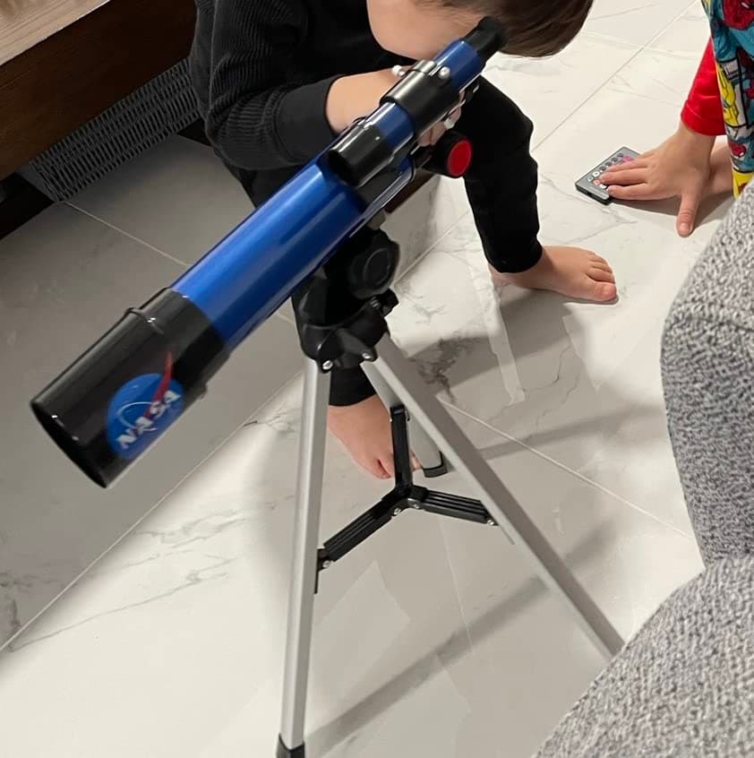 Small boy looking through the NASA Lunar Telescope