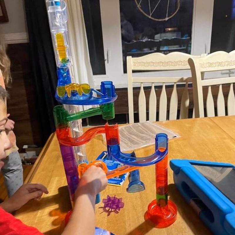 Children building and playing with the National Geographic Motorized Marble Run