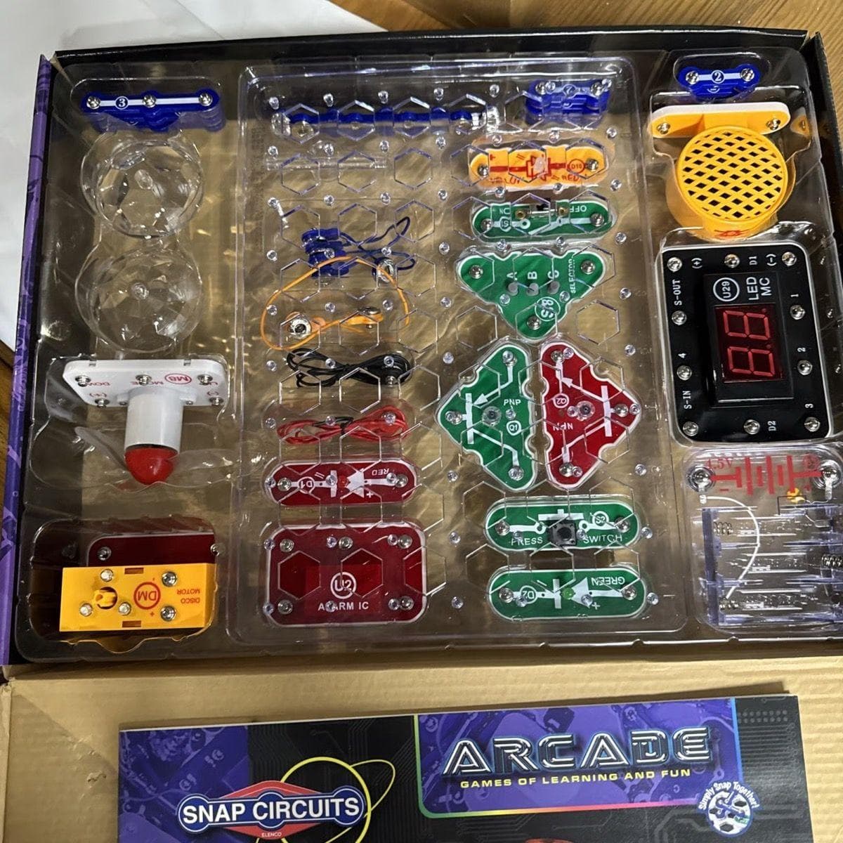 Snap Circuits Arcade components laid out from the opened box