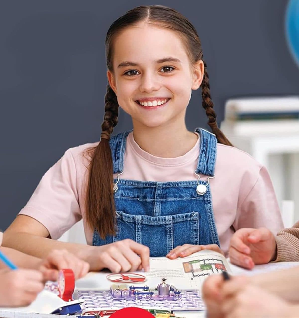Girl smiling with completed Snap Circuits kit