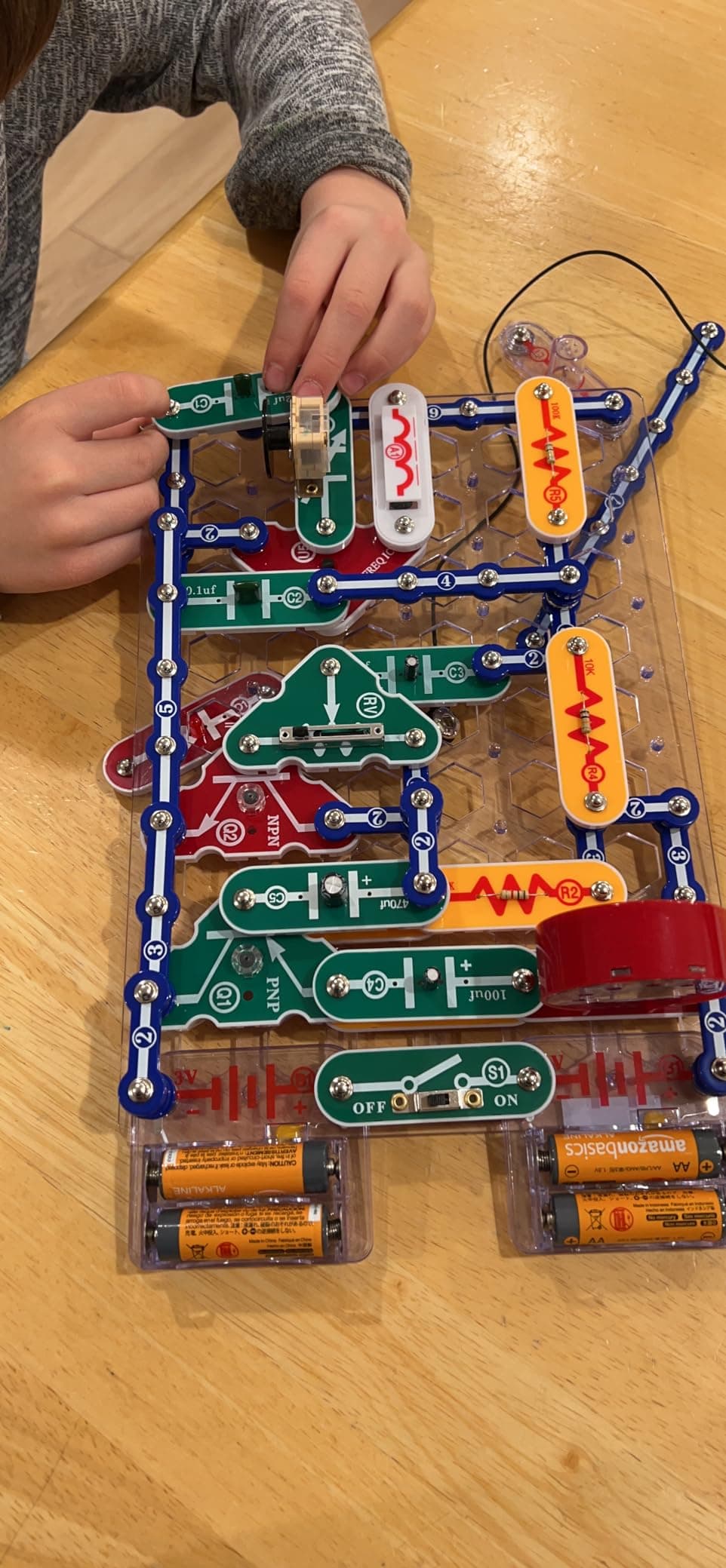 Child building a Snap Circuits project