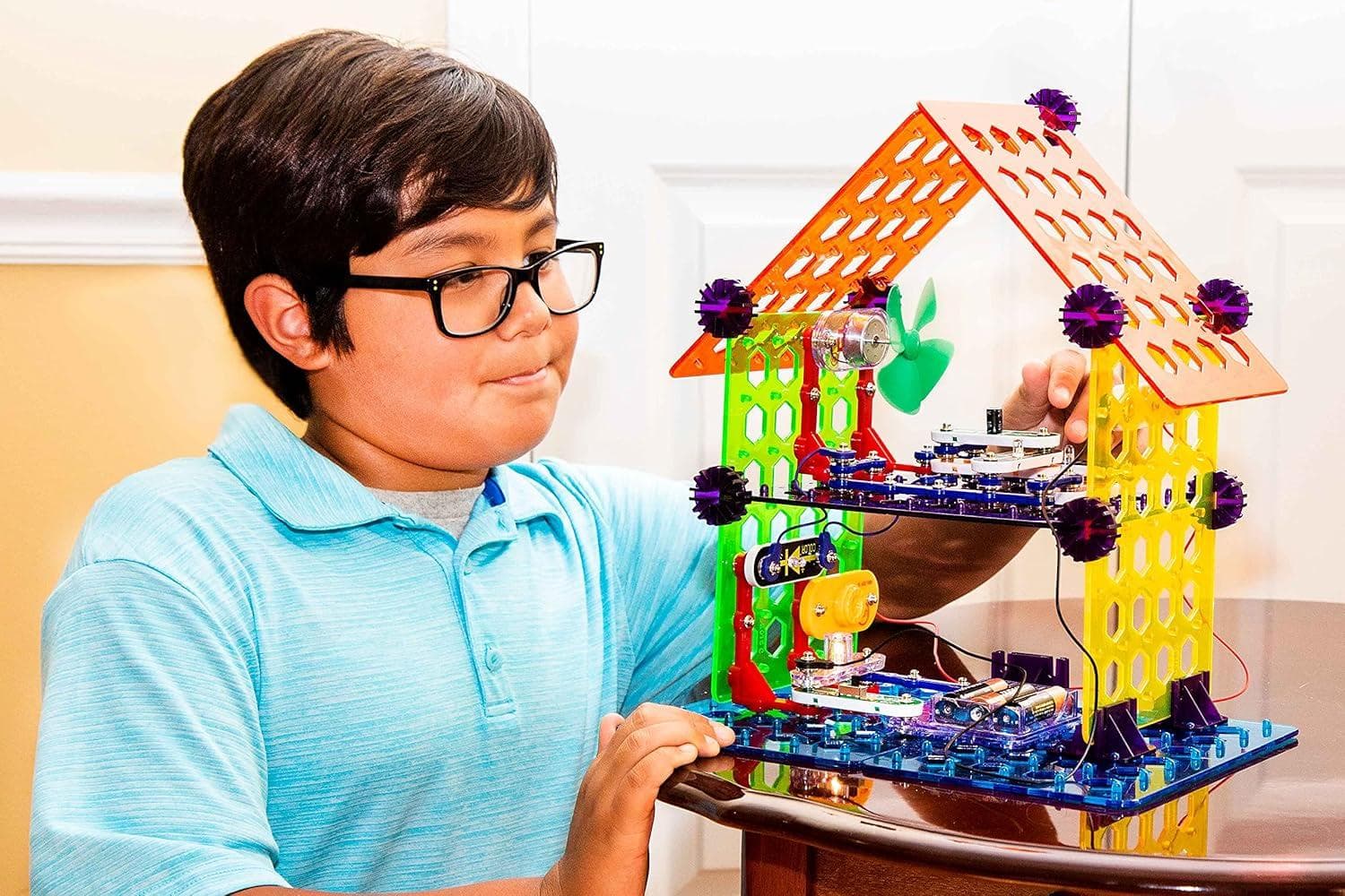 Boy playing with Snap Circuits My Home kit